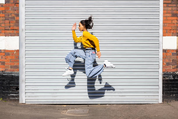 istock Happy black woman jumping and making a funny pose 1479419888
