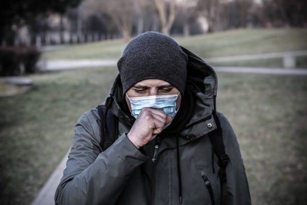 istock Coronavirus outbreak. Man in mask coughing outdoors. Dangerous flu strain cases. Pandemic disease. Health problem concept. 1479421455