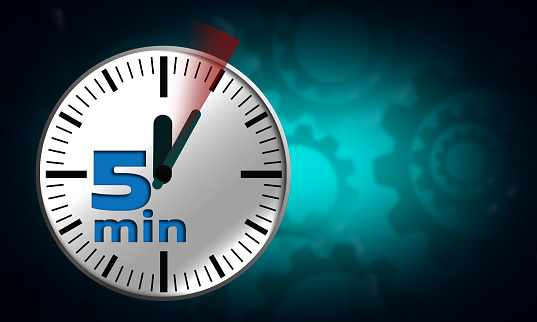 A five minutes timer on a white clock face on a blurred background