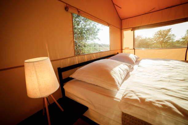 istock Interior of Cozy open glamping tent with light inside during sunset. Luxury camping tent for outdoor summer holiday and vacation. Lifestyle concept 1479422298
