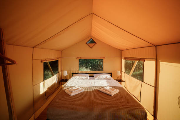 istock Interior of Cozy open glamping tent with light inside during sunset. Luxury camping tent for outdoor summer holiday and vacation. Lifestyle concept 1479423071