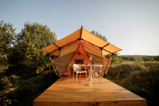 istock Cozy open glamping tent with light inside during sunset. Luxury camping tent for outdoor summer holiday and vacation. Lifestyle concept 1479423073