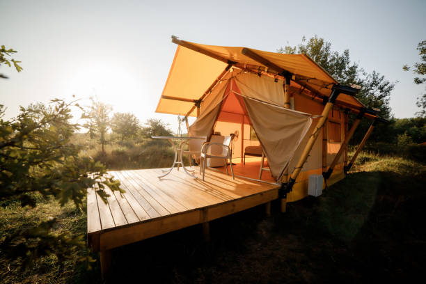 istock Cozy open glamping tent with light inside during sunset. Luxury camping tent for outdoor summer holiday and vacation. Lifestyle concept 1479423074