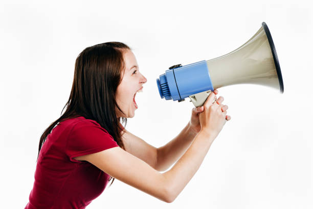 istock Pretty brunette yells into loud hailer 147942328