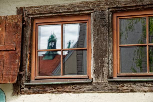 istock Old wooden window reflecting a German city view 1479424874