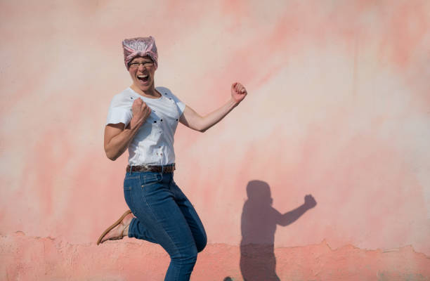 istock Woman with cancer jumping happily 1479427710