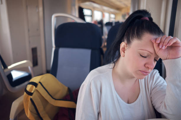 istock Woman sleeping in a train seat while travelling. 1479431112