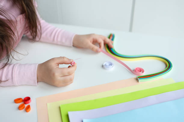 istock Children's activities, hands with paper top view, quilling technology 1479435524
