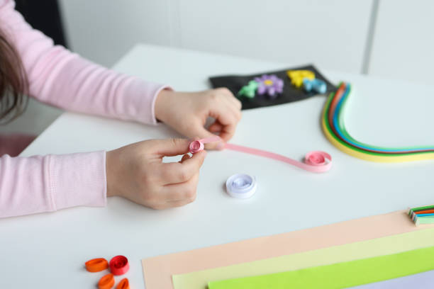 istock Children's activities, hands with paper top view, quilling technology 1479435526