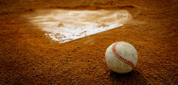 Old Leather Baseball on Field by Home Plate or Base Old leather baseball on dirt field by home plate or a base base sports equipment stock pictures, royalty-free photos & images