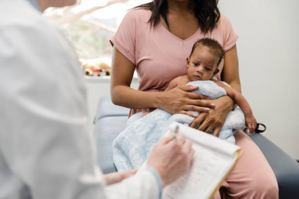 istock Unrecognizable doctor asks young mom with cute baby questions 1479437041