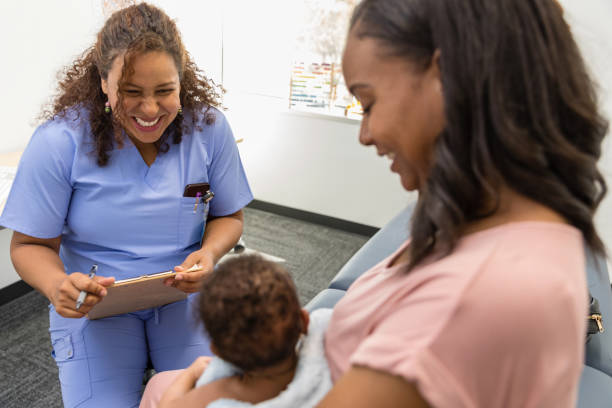 istock Mature female nurse practitioner cannot help smiling at baby 1479437053