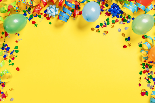 Decoration party on colorful yellow background with copy space top view
