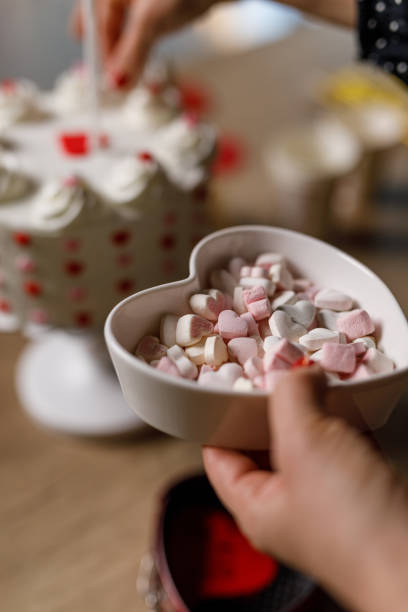 istock Woman decorating a birthday cake with heart shaped candy 1479438490