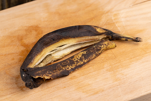 black long-lasting ripe banana, still an edible banana whose peel is covered with black spots