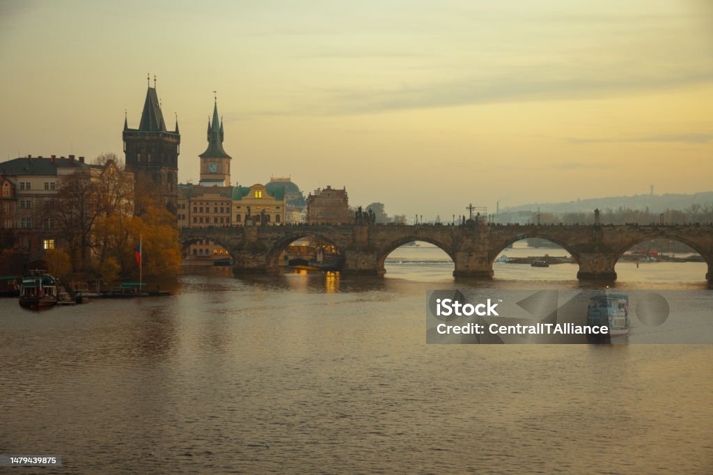 landscape with Vltava river, Karlov most and boat landscape with Vltava river, Karlov most and boat at sunset in autumn in Prague, Czech Republic. Architectural Dome Stock Photo