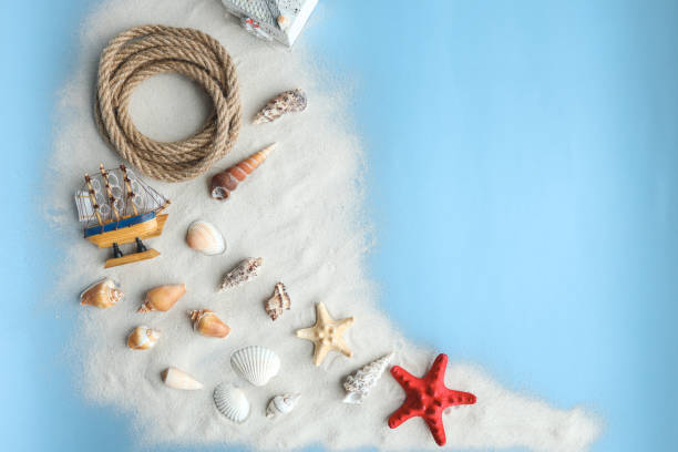 istock Marine summer composition. Shells, ship, rope on a blue background 1479440475