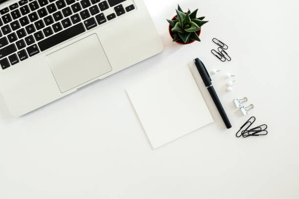 istock White office desk table with blank notebook, computer keyboard and other office supplies. Top view with copy space, flat lay. 1479440480
