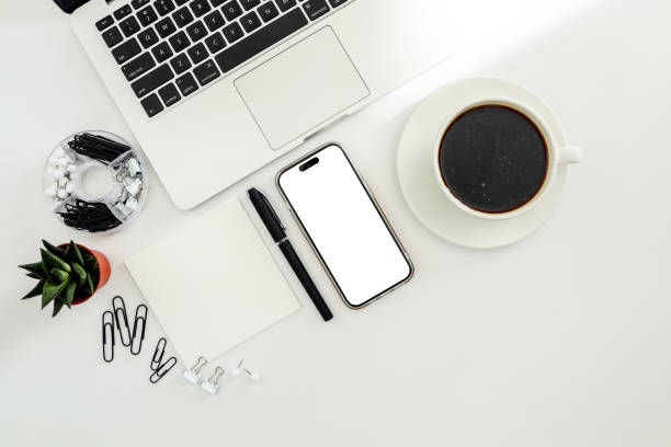 istock White office desk table with blank notebook, computer keyboard and other office supplies. Top view with copy space, flat lay. 1479440505