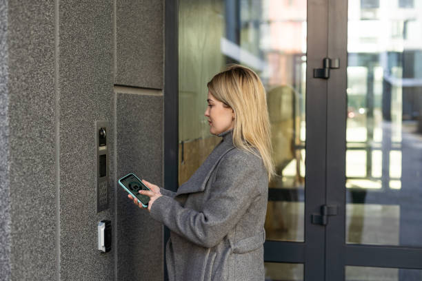 istock Woman hands using phone scan to digital door lock security systems at home. 1479441568