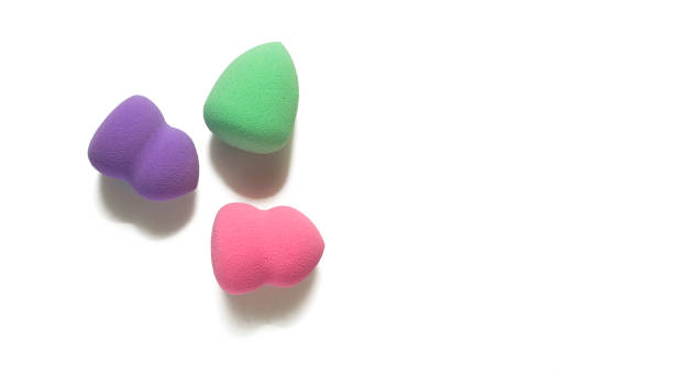 istock Colored makeup sponges purple, pink, green on a white background. Means for applying professional make-up 1479443829