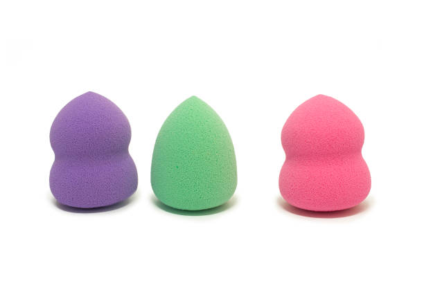 istock Colored makeup sponges purple, pink, green on a white background. Means for applying professional make-up 1479443836