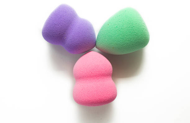 istock Colored makeup sponges purple, pink, green on a white background. Means for applying professional make-up 1479443864