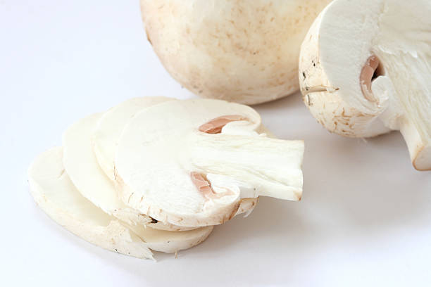 istock Cut raw mushrooms agarics on grey background 147944651