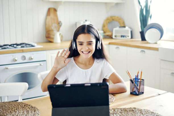 girl studying online using modern tech at home - number 12 audio imagens e fotografias de stock