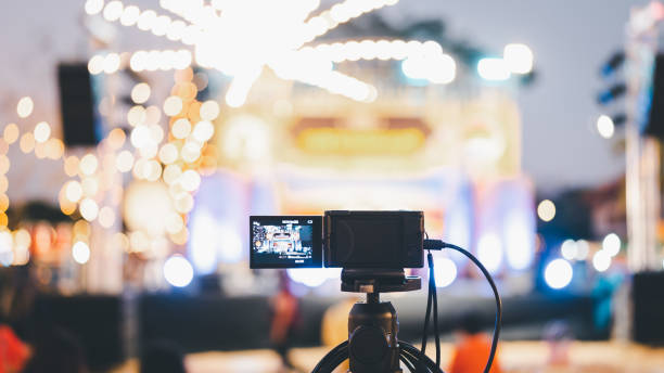 Video camera taking live video streaming with people working background at meeting room. Selective focus.