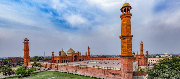 Built in 1671, Badshahi Mosque is the crown jewel of Lahore, a symbol of the Mughal Empire (1526-1857), and one of the most beautiful places in Pakistan. Its architecture is characterized by carved red sandstones, which was typical of the Mughal era.\n\nThe vast courtyard of the mosque can hold up to 100,000 worshippers, making it the second largest mosque in Pakistan! I recommend spending at least a couple of hours here to admire all the marvelous details of the architecture.