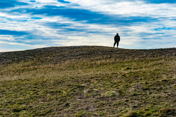 silhouette, soldier, standing, hilltop, winter sunlight