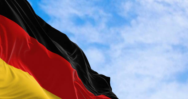 istock Germany national flag waving in the wind on a clear day 1479454691