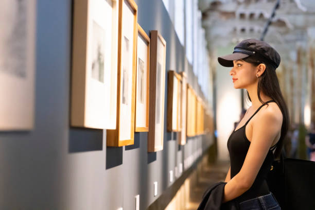 Young woman appreciating works of art Young woman appreciating works of art gallery opening stock pictures, royalty-free photos & images