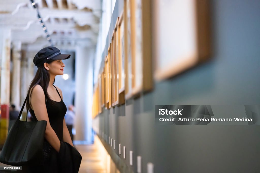 Young woman appreciating works of art in the museum Museum Stock Photo