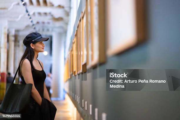 Young Woman Appreciating Works Of Art In The Museum Stock Photo - Download Image Now