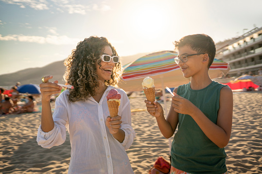 People eating ice cream cone on the beach