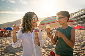 People eating ice cream cone on the beach