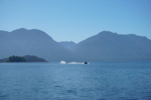 Image of a person doing water ski in the lake. Beautiful sunny day.