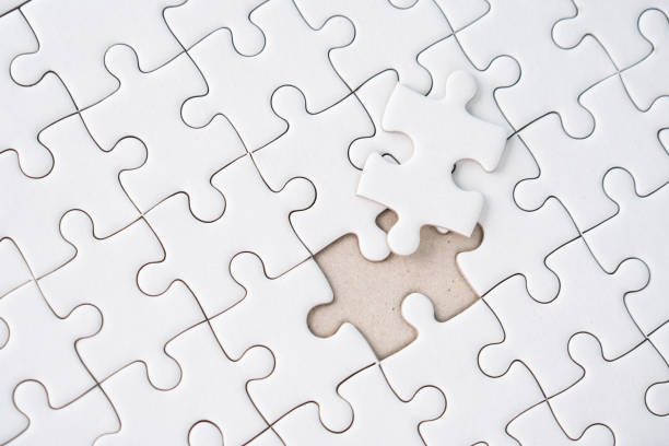 istock White jigsaw puzzle background for business concept of strategy solution 1479458345