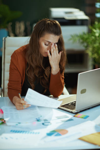 istock business owner woman in green office working with documents 1479458568