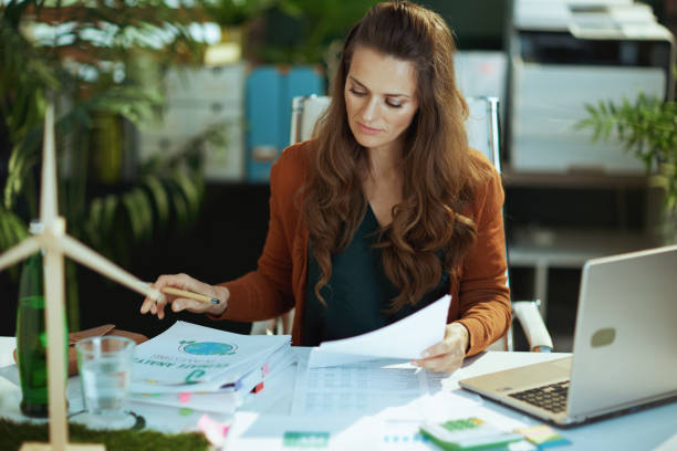 istock business owner woman in green office working with documents 1479458569