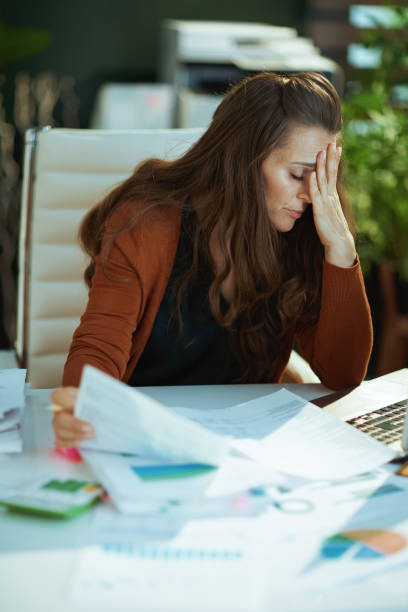 istock business owner woman in green office working with documents 1479458579