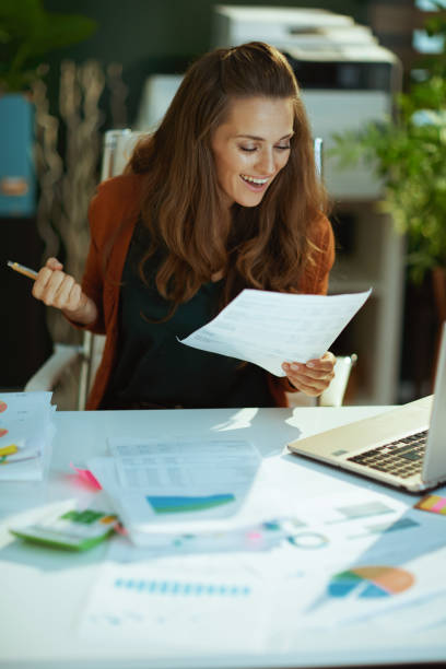 istock happy business owner woman rejoicing working with documents 1479458581