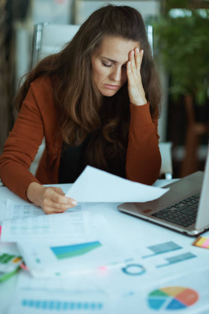 istock business owner woman in green office working with documents 1479458595