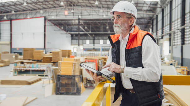 senior manager using a tablet in the factory stock photo