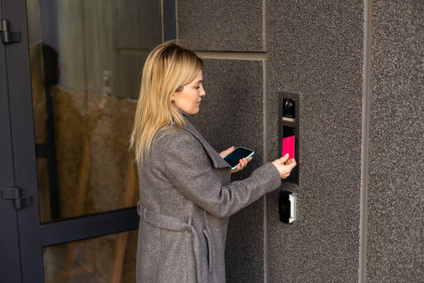 istock Middle aged woman pushing button of intercom 1479460648