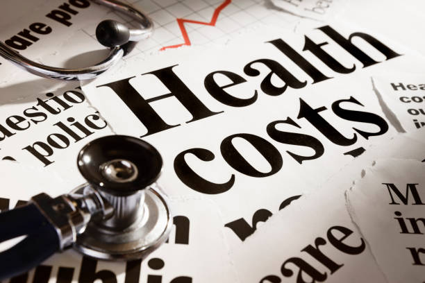 istock Stethoscope rests on headlines concerning health costs, plus rising graph 147946186