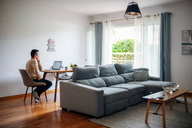 istock Man on the phone using laptop at home. 1479462150