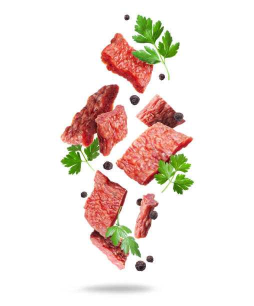istock Beef jerky pieces with dill leaves in the air isolated on white background 1479463203